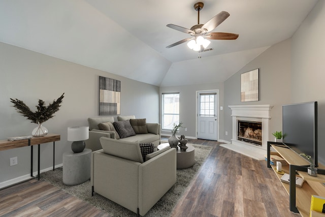 living room featuring a fireplace with raised hearth, visible vents, dark wood-type flooring, vaulted ceiling, and baseboards