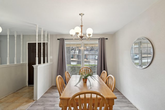 dining area with a chandelier and light wood-style floors