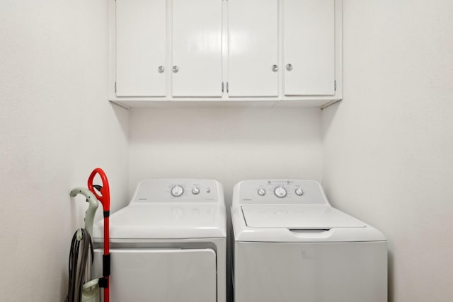 laundry area with cabinet space and separate washer and dryer