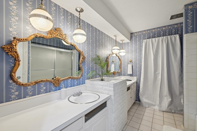 full bathroom featuring tile patterned floors, vanity, curtained shower, and wallpapered walls