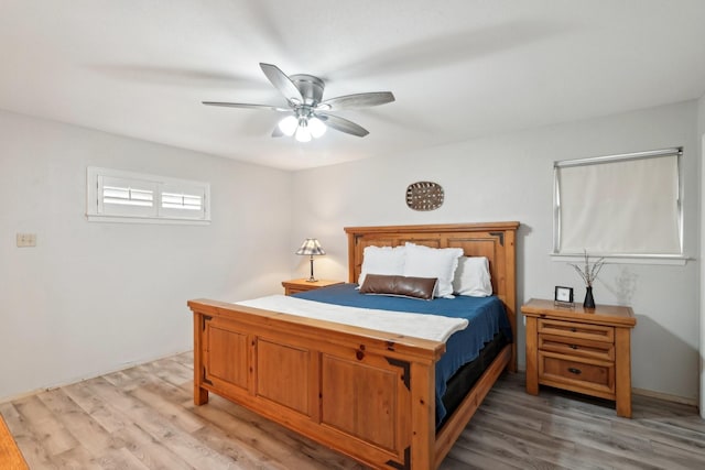 bedroom with light wood-style flooring and a ceiling fan