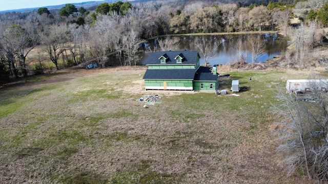 bird's eye view with a water view and a wooded view