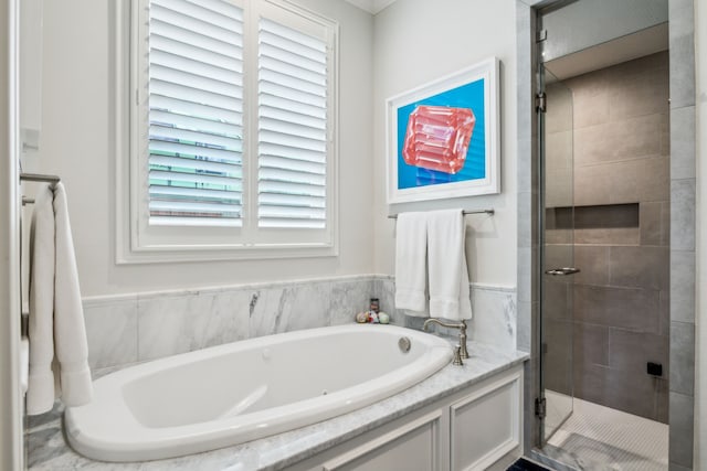 bathroom with a stall shower and a bath