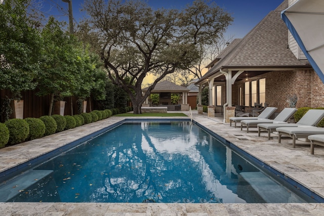 pool with outdoor lounge area, a patio, and a gazebo