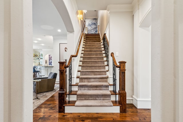 stairway featuring ornamental molding, wood finished floors, and recessed lighting