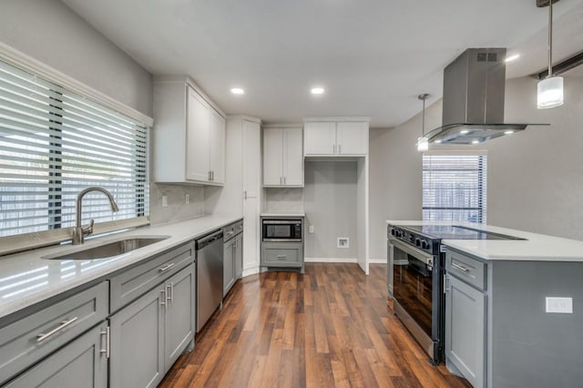 kitchen featuring a sink, appliances with stainless steel finishes, island exhaust hood, and pendant lighting