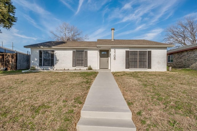 single story home with a front yard, fence, and brick siding