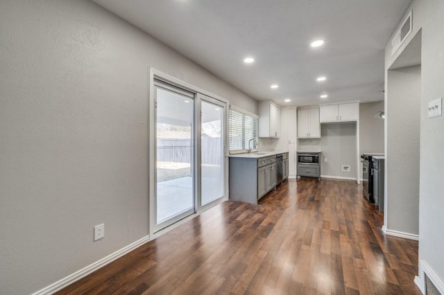 kitchen with stainless steel appliances, light countertops, visible vents, and white cabinetry