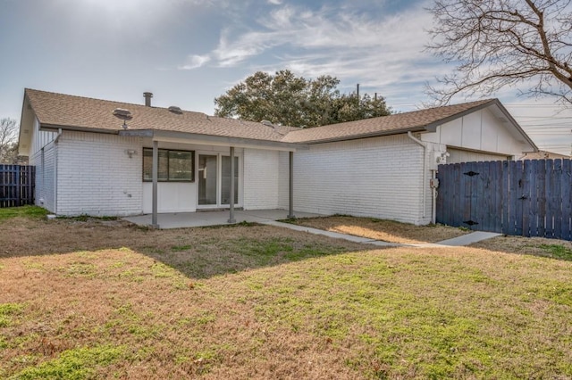 ranch-style house featuring brick siding, an attached garage, fence, a patio area, and a front yard