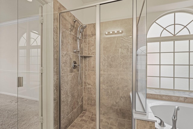 full bathroom featuring a stall shower, crown molding, and a bath