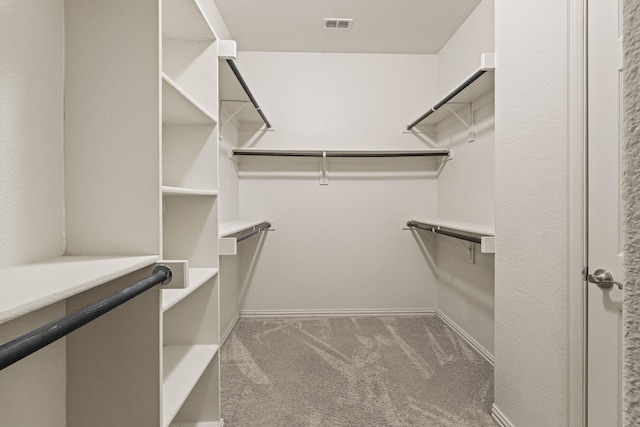 walk in closet featuring carpet flooring and visible vents