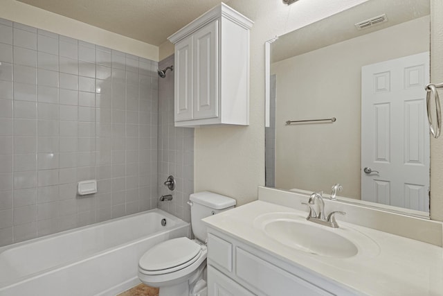 bathroom with bathtub / shower combination, visible vents, toilet, vanity, and a textured ceiling