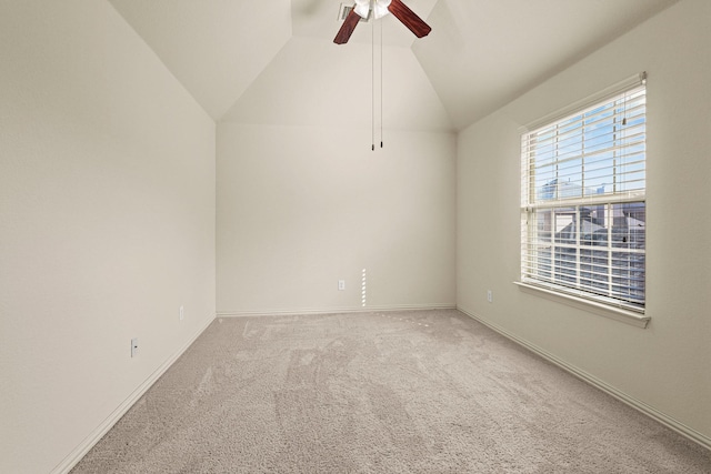 spare room featuring vaulted ceiling, ceiling fan, carpet, and baseboards