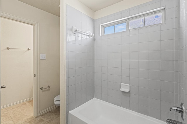 full bath with shower / bathtub combination, tile patterned floors, toilet, and baseboards