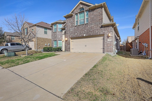 traditional home featuring brick siding, central air condition unit, an attached garage, driveway, and a front lawn