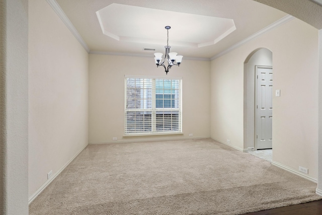 spare room with arched walkways, light carpet, a raised ceiling, and visible vents