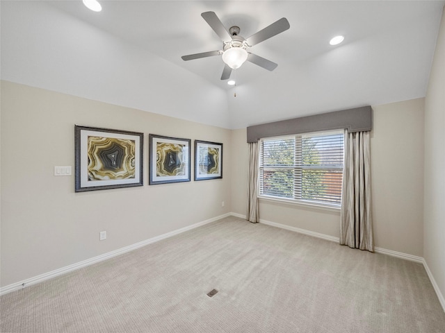 spare room with recessed lighting, baseboards, vaulted ceiling, and light colored carpet