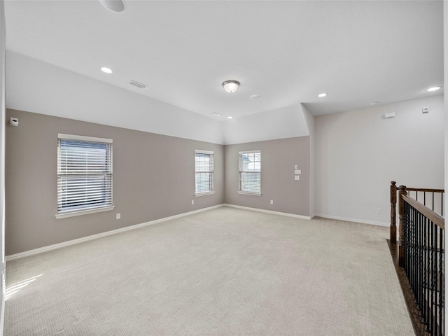 unfurnished room with recessed lighting, visible vents, light carpet, and baseboards