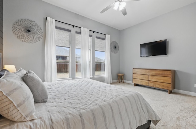 bedroom with baseboards, light colored carpet, and a ceiling fan