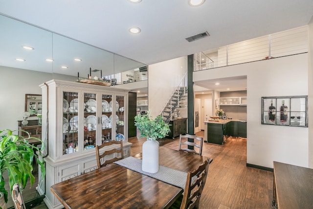 dining room featuring stairs, visible vents, dark wood-style flooring, and recessed lighting