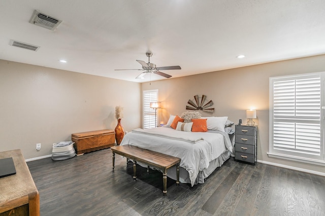 bedroom featuring a ceiling fan, baseboards, visible vents, and dark wood-style flooring