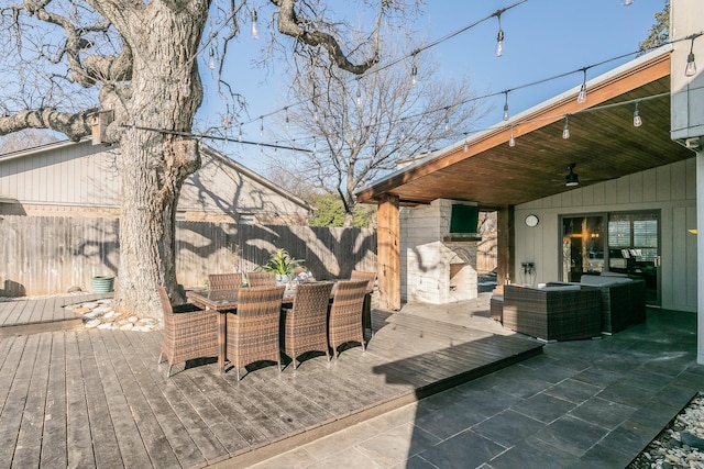 wooden deck with outdoor lounge area, fence, outdoor dining area, and a ceiling fan