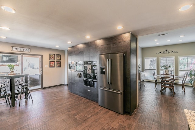 kitchen with dark wood-style flooring, recessed lighting, visible vents, modern cabinets, and high end refrigerator