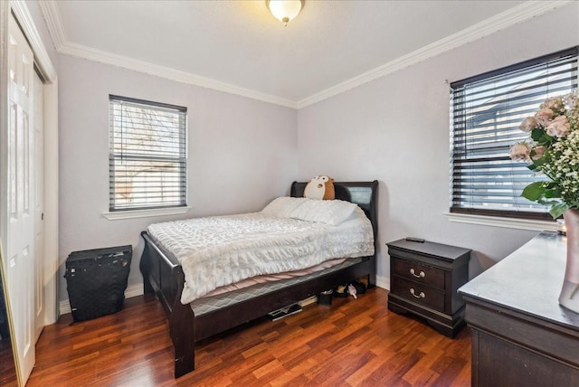 bedroom featuring baseboards, a closet, ornamental molding, and dark wood-style flooring