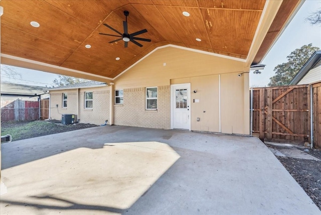 view of patio featuring cooling unit, a gate, fence, and a ceiling fan