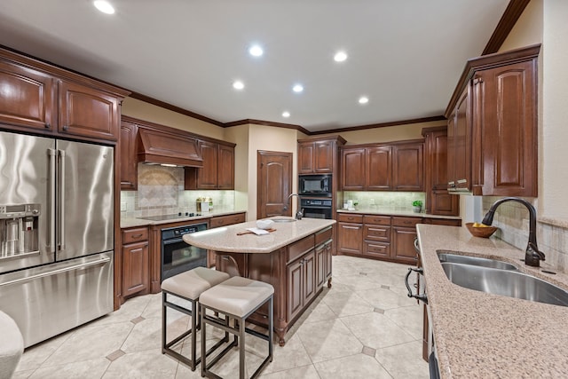 kitchen with black appliances, premium range hood, a sink, and crown molding