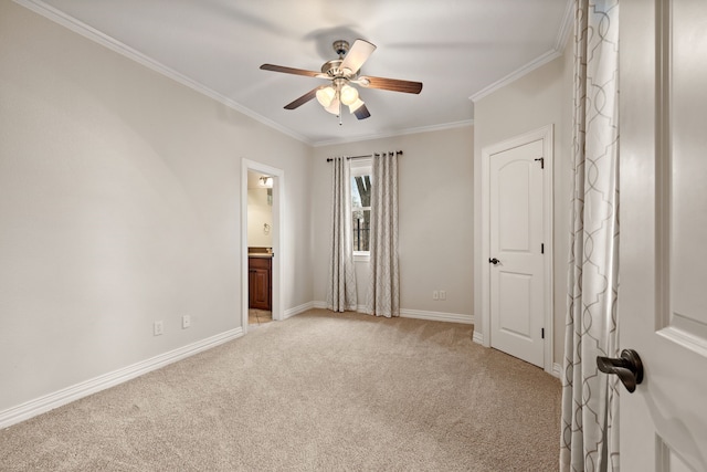 unfurnished bedroom featuring ornamental molding, carpet, ensuite bath, and baseboards