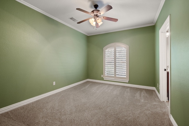 unfurnished room featuring visible vents, ornamental molding, a ceiling fan, carpet flooring, and baseboards