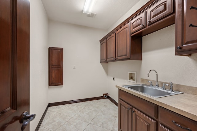 kitchen featuring baseboards, visible vents, light countertops, and a sink