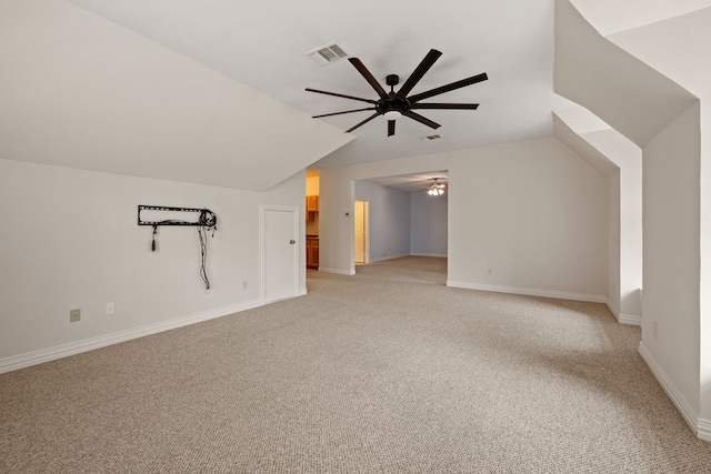 additional living space with lofted ceiling, visible vents, a ceiling fan, and light colored carpet