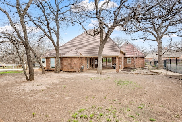 back of house with a patio area, brick siding, and fence