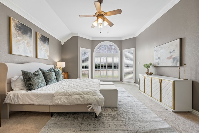 bedroom featuring light carpet, a ceiling fan, baseboards, vaulted ceiling, and ornamental molding