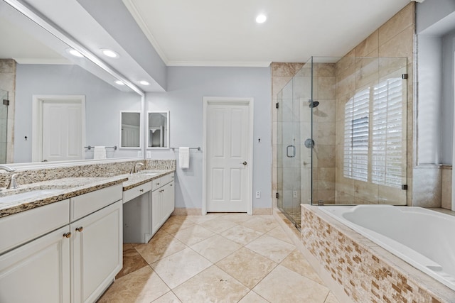 full bathroom with double vanity, a stall shower, crown molding, and a sink