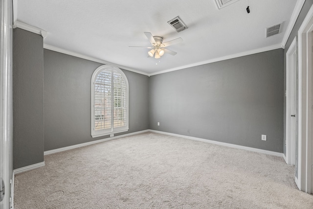 unfurnished room featuring light colored carpet, visible vents, and crown molding