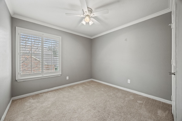 empty room with crown molding, light carpet, ceiling fan, and baseboards