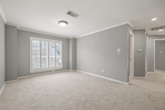 empty room with baseboards, visible vents, ornamental molding, and light colored carpet