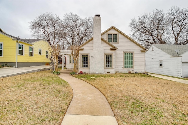 view of front of home featuring crawl space, a chimney, and a front lawn