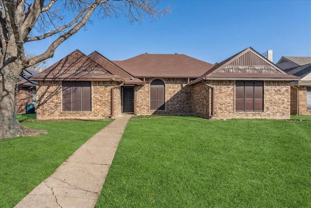 ranch-style home with a front yard and brick siding