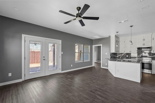 kitchen with white cabinets, french doors, stainless steel electric range oven, dark countertops, and pendant lighting