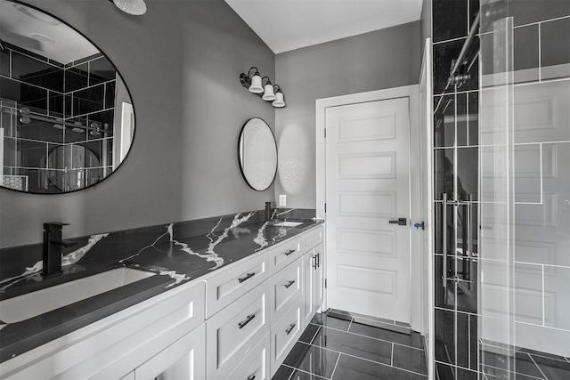 full bathroom featuring double vanity, tile patterned flooring, and a sink