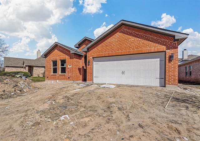 ranch-style house with a garage and brick siding