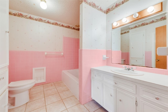 bathroom featuring tile patterned flooring, a wainscoted wall, a textured ceiling, and wallpapered walls