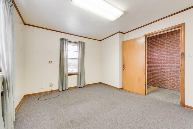 spare room with light carpet, baseboards, and crown molding