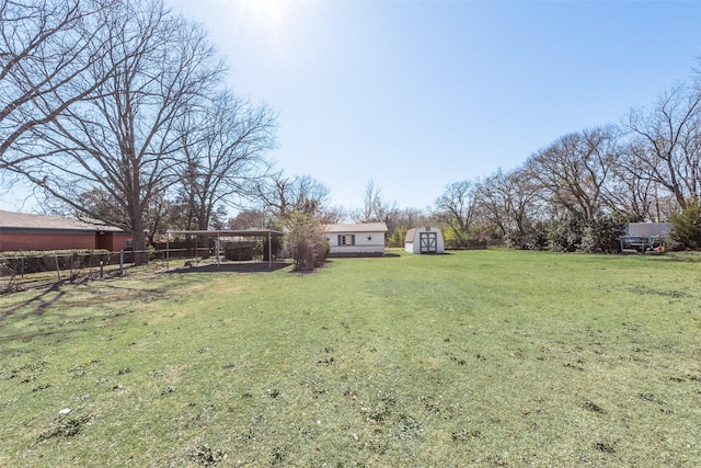 view of yard featuring an outdoor structure, a storage shed, and fence