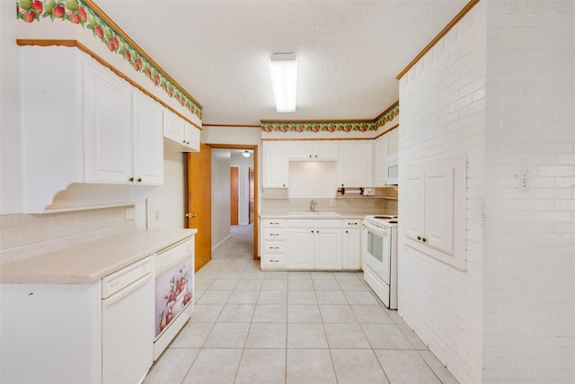 kitchen featuring white appliances, light countertops, a textured ceiling, white cabinetry, and a sink