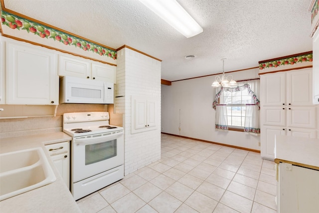 kitchen featuring pendant lighting, white appliances, a sink, light countertops, and an inviting chandelier